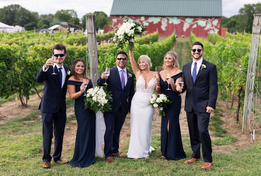 wedding party celebrating in vineyard