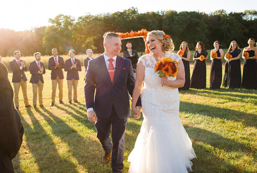 bride and groom running in sunlight